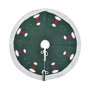 Dark green Christmas tree skirt with white borders and red festive hat patterns