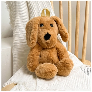 Close-up of golden plush puppy backpack with soft furry texture and yellow hanging strap