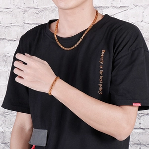 Men's golden Byzantine chain necklace and bracelet set displayed on a male model
