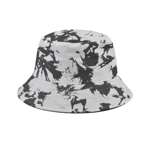 Detailed view of tie-dye artistic pattern on black and white canvas bucket hat fabric