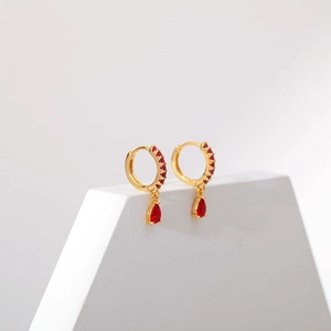 Exquisite 18K gold plated hoop earrings with red zircon teardrop pendant on white stand
