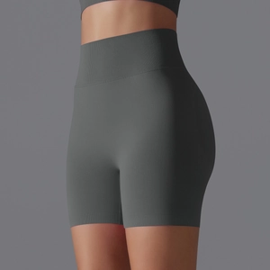 Detail of high-waisted seamless yoga shorts in dark grey with wide ribbed waistband