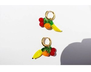Detailed close-up of colorful fruit-shaped glass charms and gold plated 18K hoop earrings