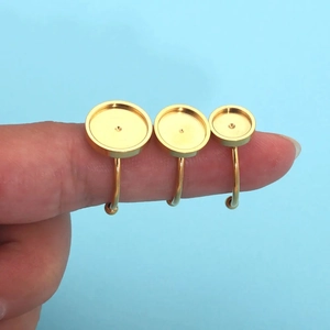 Three gold stainless steel ring blanks for jewelry making shown on finger for scale