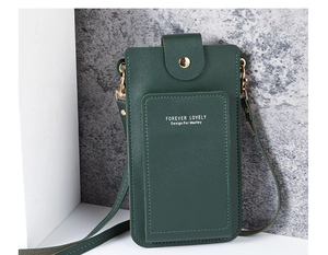 Detail view of the dark green faux leather phone bag with gold clasp and card slots