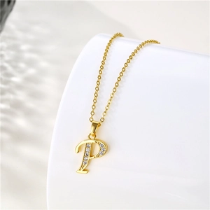 Close-up of golden letter P pendant with crystals on a polished stainless steel chain