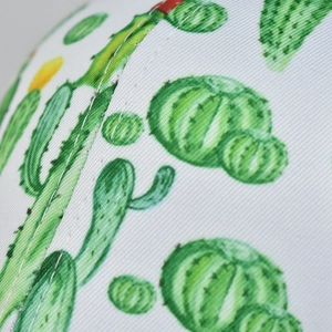 Macro shot of white twill fabric featuring cactus floral print and detailed stitching