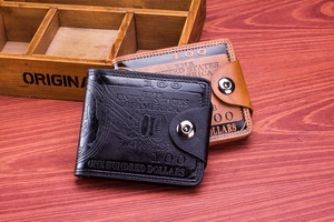 Close-up of leather wallets featuring embossed hundred dollar bill design and snap closure