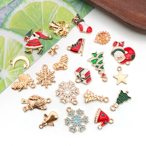 Flat lay of colorful enamel Christmas charms featuring Santa and trees for DIY jewelry
