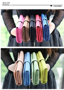 Detalle de carteras largas de cuero multicolor con cierre a presión para mujer