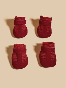 Close-up of red breathable mesh dog shoes with adjustable velcro straps and soft sole