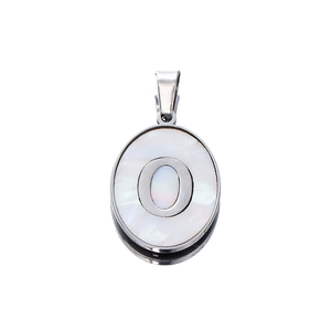 Macro detail of oval stainless steel pendant with white shell inlay and letter O
