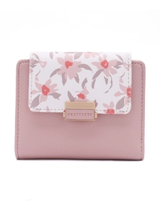 Close-up of pink PU leather wallet with floral print and gold metal buckle detail