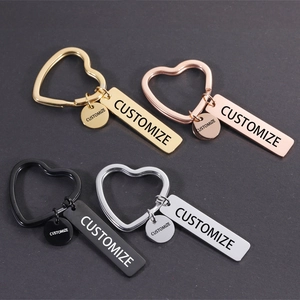 Close-up of four metal heart keychains in gold, rose gold, black and silver finishes