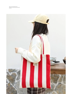 Close-up of red and white striped canvas tote bag showing the high-quality fabric texture