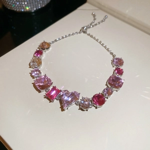 Macro detail of 18K gold plated bracelet with pink heart-shaped zircon stones