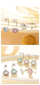 Macro shot of heart-shaped navel rings with colorful stones and screw-on ball closures