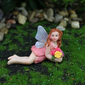 Lying flower fairy resin figurine with pink dress and silver wings in garden miniature