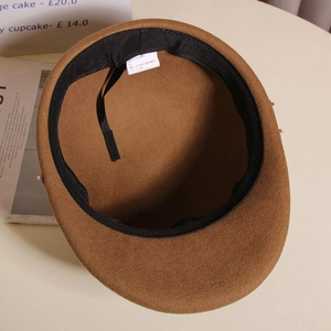 Detail view of the interior wool lining and adjustable strap of the brown equestrian hat