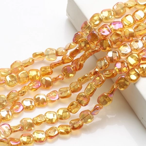 Macro view of golden rainbow luster rhombus glass beads for jewelry making DIY