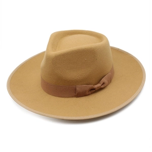 Close-up of a camel wool fedora hat featuring a wide brim and elegant satin bow detail
