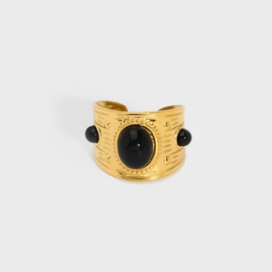 Vintage gold wide open bangle featuring relief texture and black oval gemstone inlays