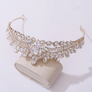 Detail of elegant gold bridal crown featuring sparkling crystal leaves and floral patterns