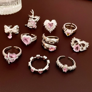 Set of 10 silver rings featuring pink zircon stones in heart and star designs