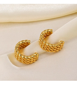 Detailed view of 18K gold plated C-shaped twisted rope earrings on soft beige silk