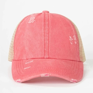 Detailed view of coral pink distressed cotton baseball cap with breathable beige mesh backing