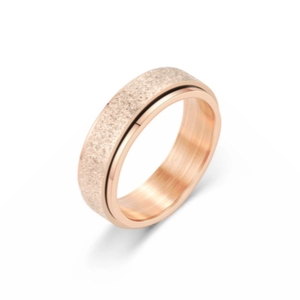 Detail view of rose gold spinner ring with matte texture and polished inner surface