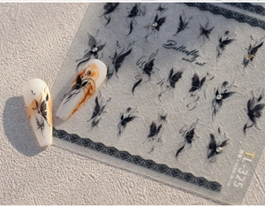 Detail of 3D vintage pearl and black butterfly nail art stickers with rhinestone accents