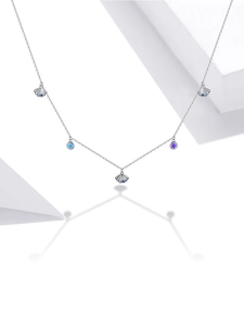 Detail of silver S925 shell pendant necklace with blue and purple zircons on white props