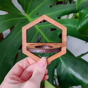 Close-up of hexagonal wooden hydroponic plant holder with natural brown grain texture