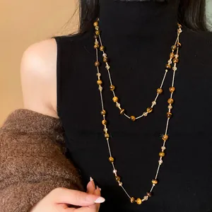 Close-up of elegant double-layer necklace with tiger eye beads and faceted crystals