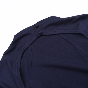 Detail of dark blue dress shoulder showing high-quality fabric and twin fabric buttons