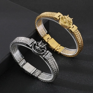 Close-up of titanium steel dragon bracelets in gold and silver with woven texture