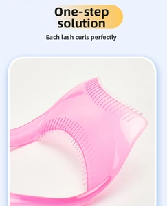 Detail of pink transparent eyelash separator comb tool with fine parallel bristles