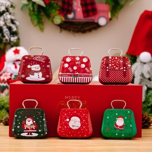 Set of six mini Christmas tinplate suitcases with Santa and snowman patterns and handles