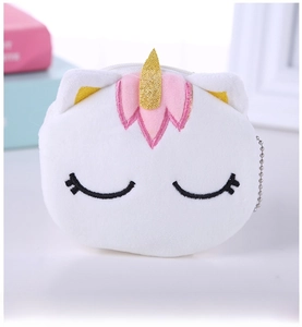Detail of plush unicorn coin purse featuring soft white fur and golden horn embroidery