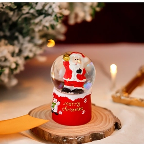 Detailed view of Santa Claus snow globe on wooden slab with Merry Christmas text