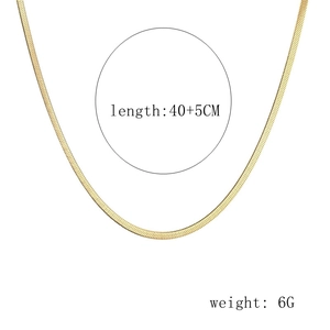 Detailed macro view of 40cm golden flat herringbone chain with 5cm extender link