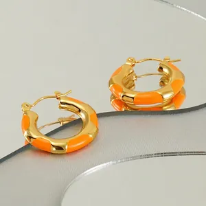 Retro gold titanium steel hoop earrings with orange enamel wave pattern design