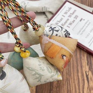 Macro view of handmade jacquard fabric Zongzi charms with colorful woven cords