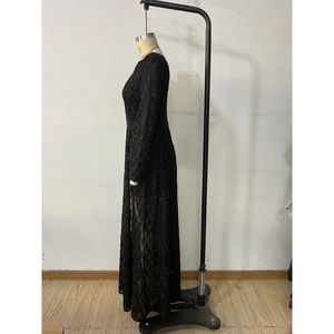 Detail of elegant black sequined evening gown with mesh texture and wave patterns