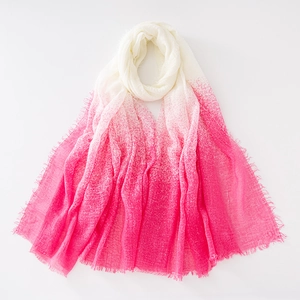 Close-up of white to pink gradient cotton scarf with fringe and crinkle texture