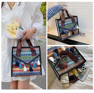 Ethnic woven tote bag featuring geometric patterns, colorful tassels, and large capacity