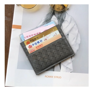 Detail of grey woven leather card holder showing multiple slots and slim textured design