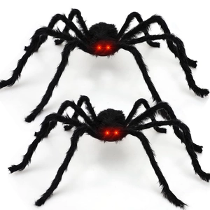 Detail of two black plush spiders with glowing red LED eyes for Halloween decoration