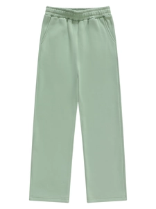 Detail of light green straight-leg sweatpants showing elastic waist and soft knit fabric